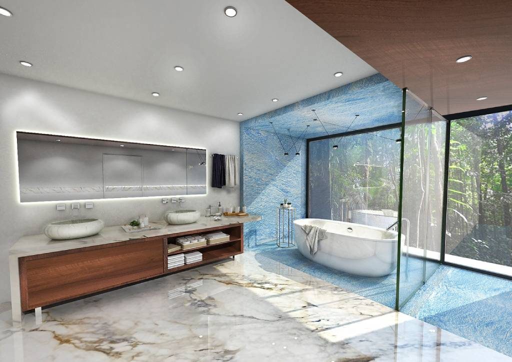 Elegant bathroom interior with statement marble flooring, illuminated vanity with twin ceramic basins, and a freestanding soaking tub framed by textured blue stone walls.