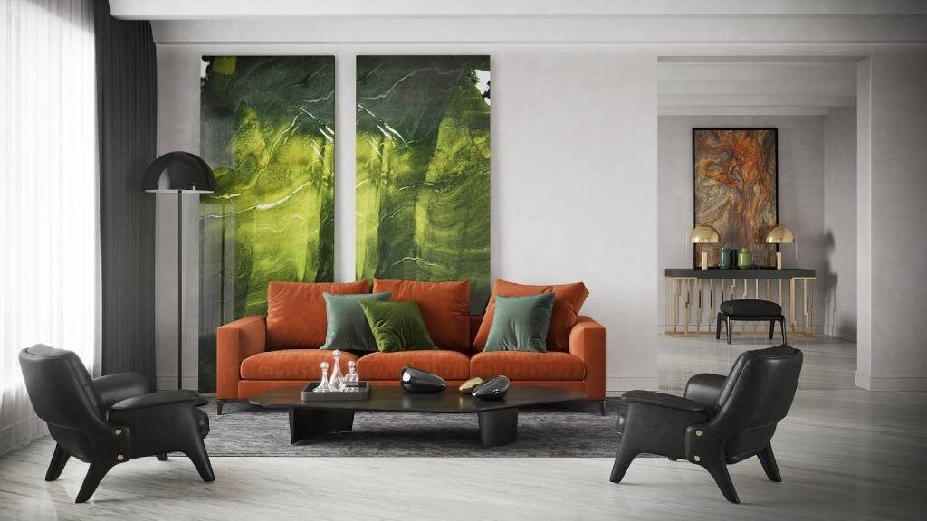 Elegant living room with an orange sofa, black lounge chairs and a low coffee table, accented by tall bookmatched green marble panels behind the seating area.